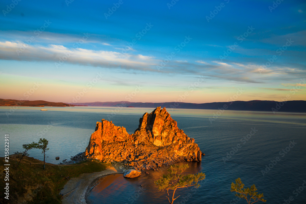 Amazing Summer sunrise  over Rock of Shamanka Burhan on Olkhon Island in Lake Baikal, Russia sunset