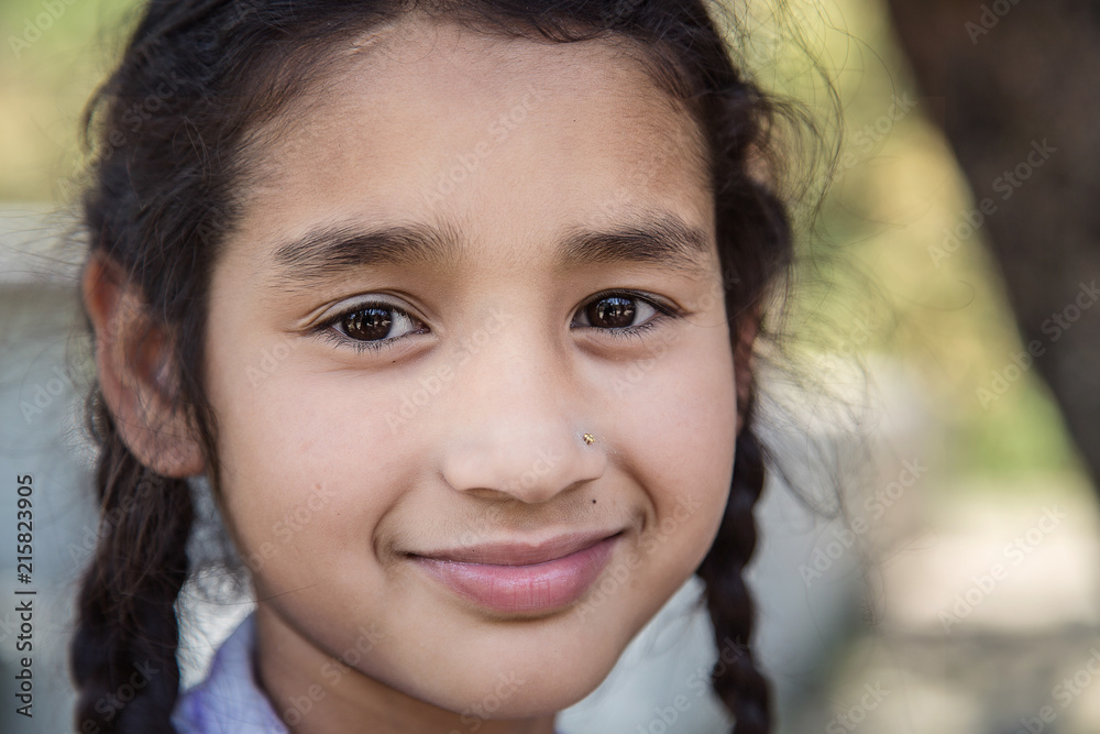 Portrait of smiling elementary Indian/Asian school girl looking at camera. Portrait of smiling elementary Indian/Asian school girl looking at camera.