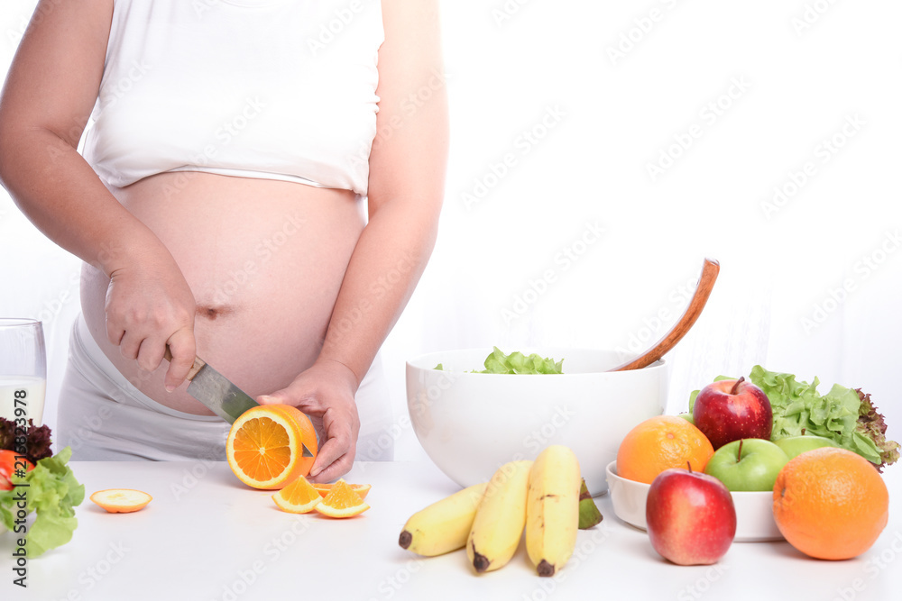 pregnant woman making salad on kitchen pregnant woman making salad on kitchen