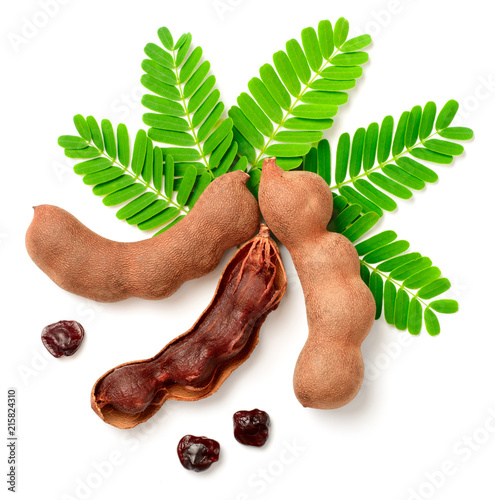 fresh tamarind fruits and leaves isolated on the white background photo