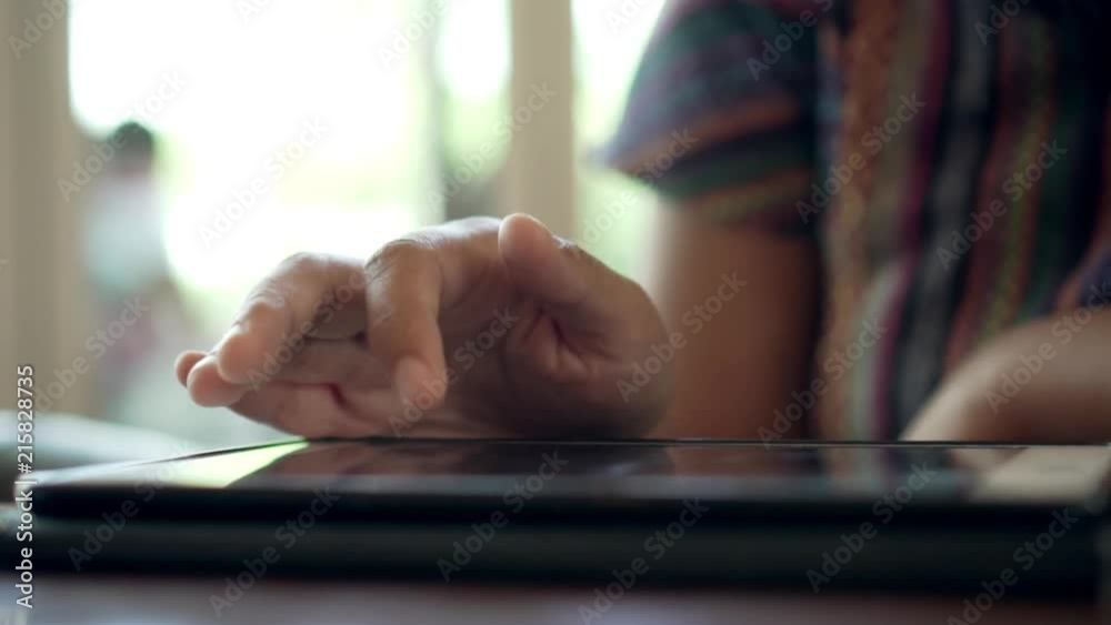 Alone young thai woman using digital tablet computer while sitting in cafe restaurant. Concept of living in the city lifestyle with technology. Slowmotion, close up Alone young thai woman using digital tablet computer while sitting in cafe restaurant. Concept of living in the city lifestyle with technology. Slowmotion, close up