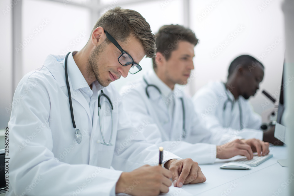 group of doctors conducting laboratory studies group of doctors conducting laboratory studies