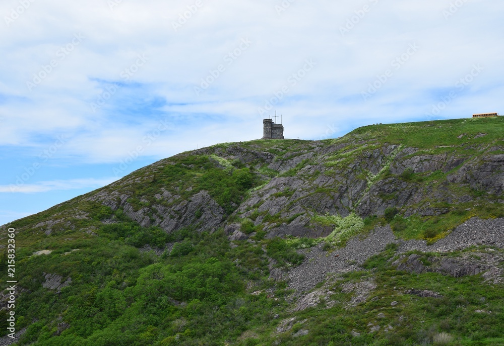 looking up from the hiking path on the bottom of Signal Hill covered with lush green grass towards the tower, St John's Newfoundland Canada looking up from the hiking path on the bottom of Signal Hill covered with lush green grass towards the tower, St John's Newfoundland Canada