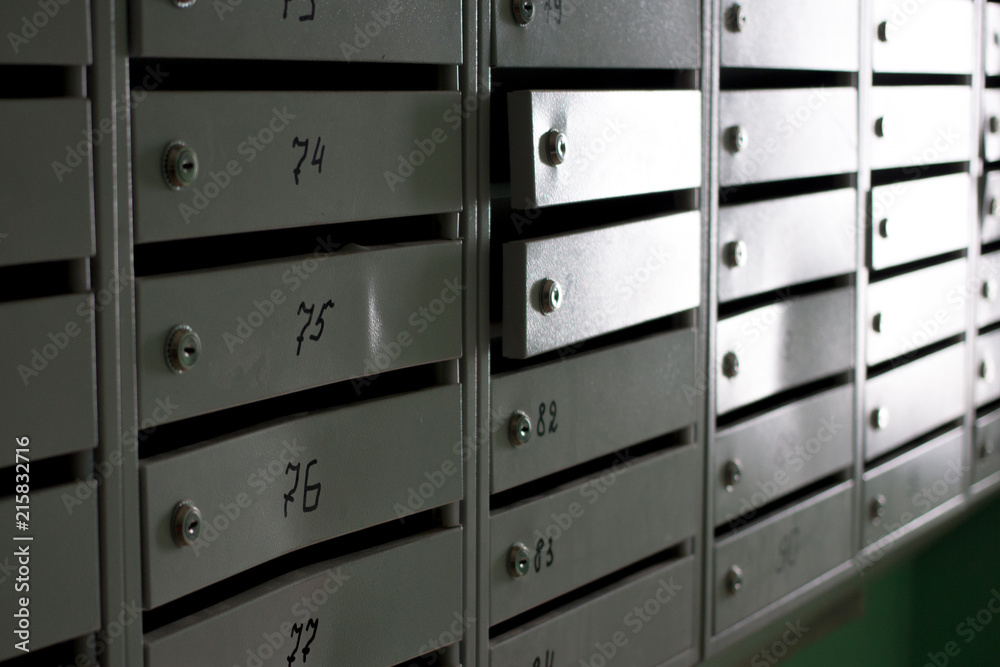gray metal mailboxes in the entrance of a apartment building gray metal mailboxes in the entrance of a apartment building
