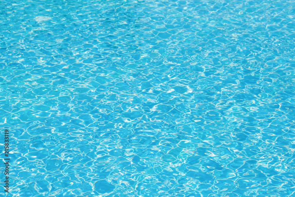 Bright water surface and ripple wave in swimming pool, Blue tile in pool with gentle wave motion and reflection
