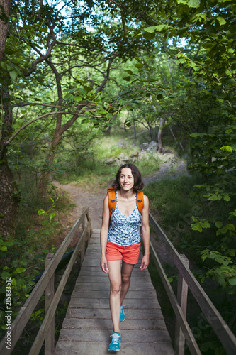 Wallpaper Mural The girl is walking along the wooden bridge. Torontodigital.ca