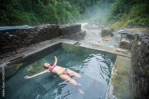Woman soaking in Jhinu Hot spring, Annapurna, Nepal.