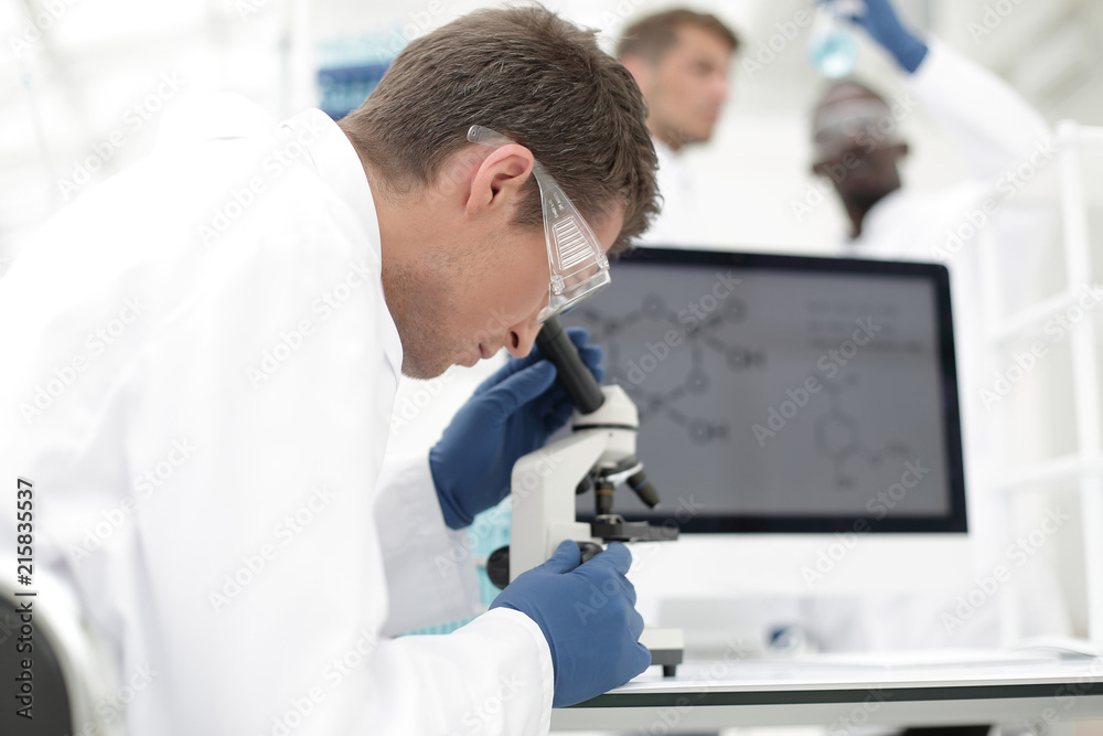 close up. the scientist works with a microscope close up. the scientist works with a microscope