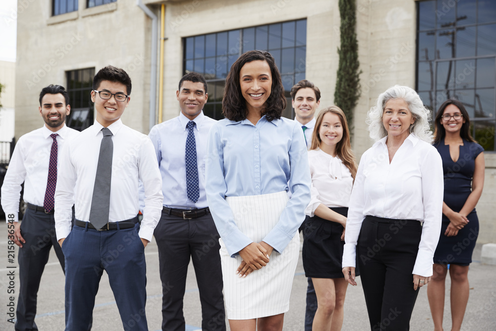 Young businesswoman and colleagues outdoors, portrait Young businesswoman and colleagues outdoors, portrait