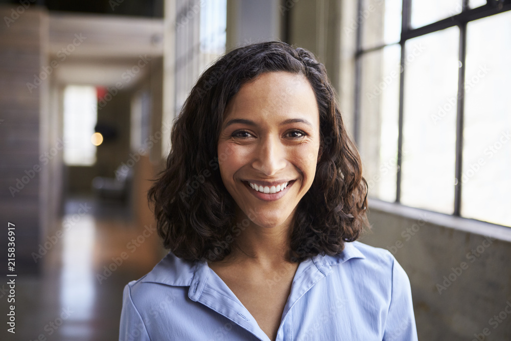 Young mixed race businesswoman smiling to camera Young mixed race businesswoman smiling to camera