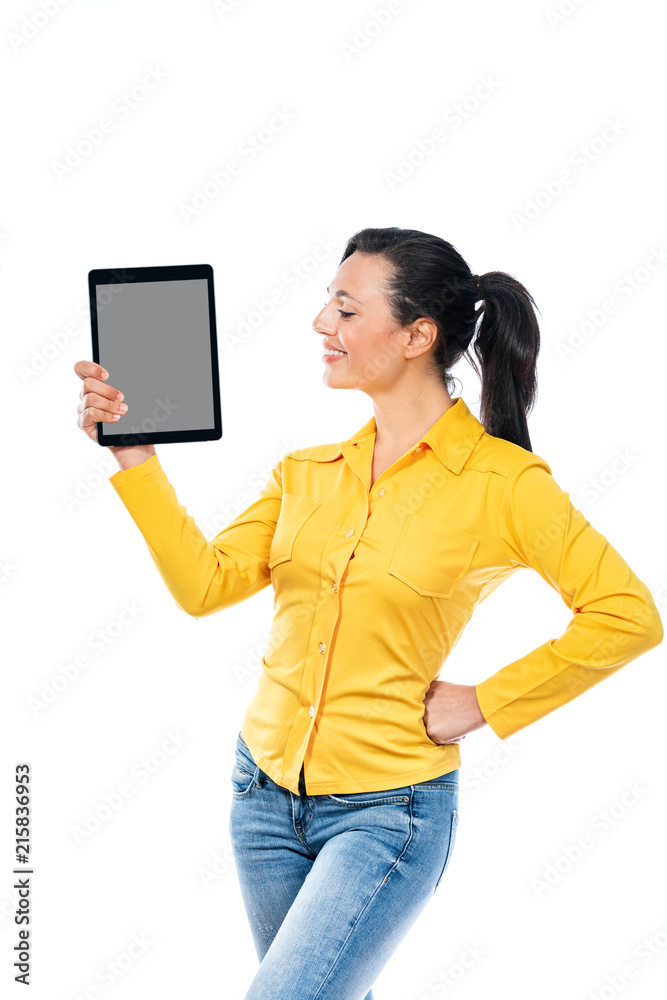 Smiling friendly young woman holding a tablet