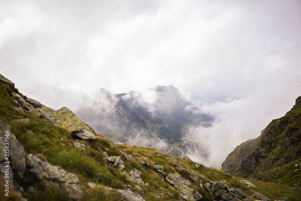 Summer landscape with high mountains and clouds in a summer day