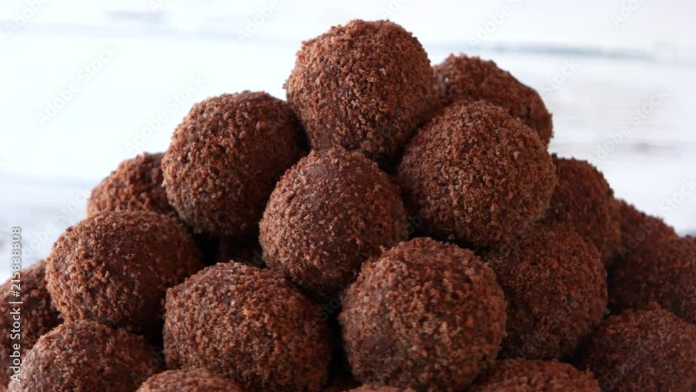 Heap of brown ball-shaped sweets. Chocolate gingerbread balls. Healthy and delicious cookies. Heap of brown ball-shaped sweets. Chocolate gingerbread balls. Healthy and delicious cookies.