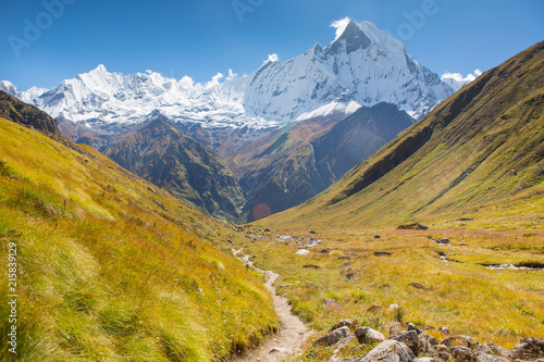 Meandering trail through beautiful Himalayan landscapes from Annapurna Base camp leading to Machapuchare.