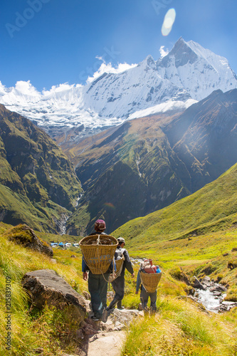 Porters carrying doko baskets, Annapurna, Himalayas, Nepal photo
