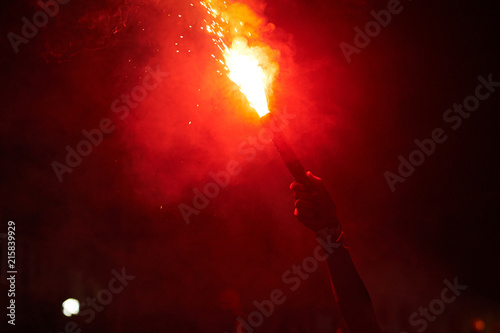 hand holding red torch