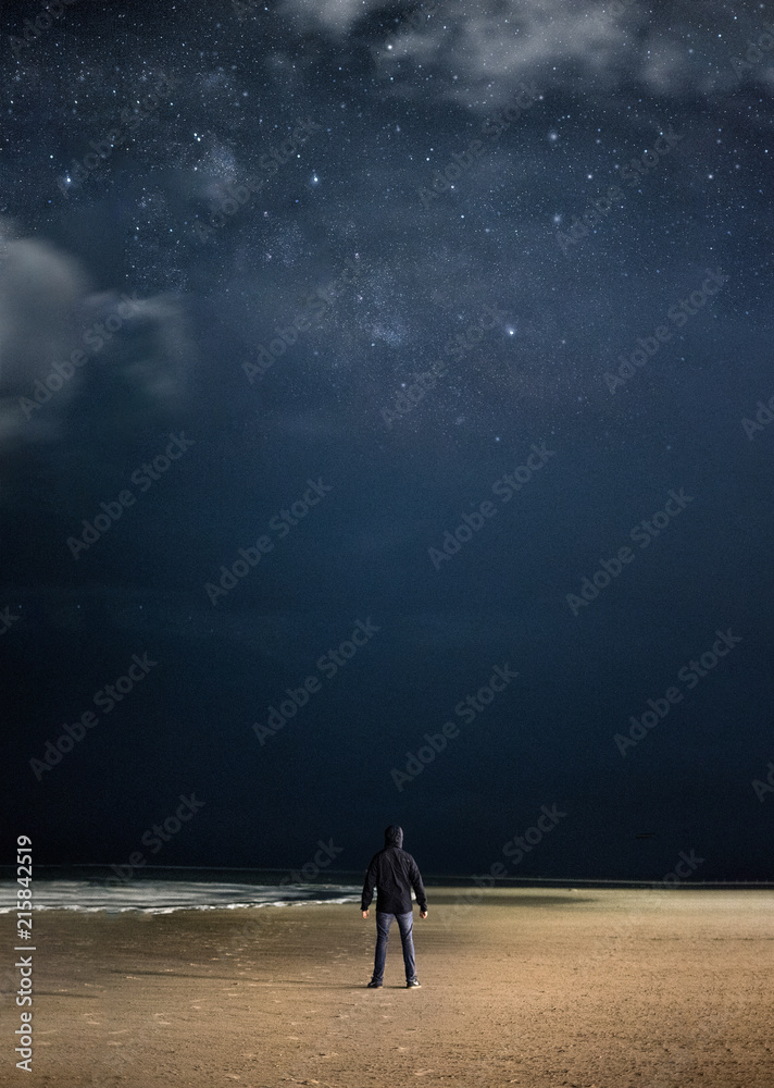 A man by the ocean at night