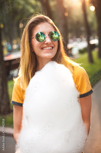Young woman posing with cotton candy.