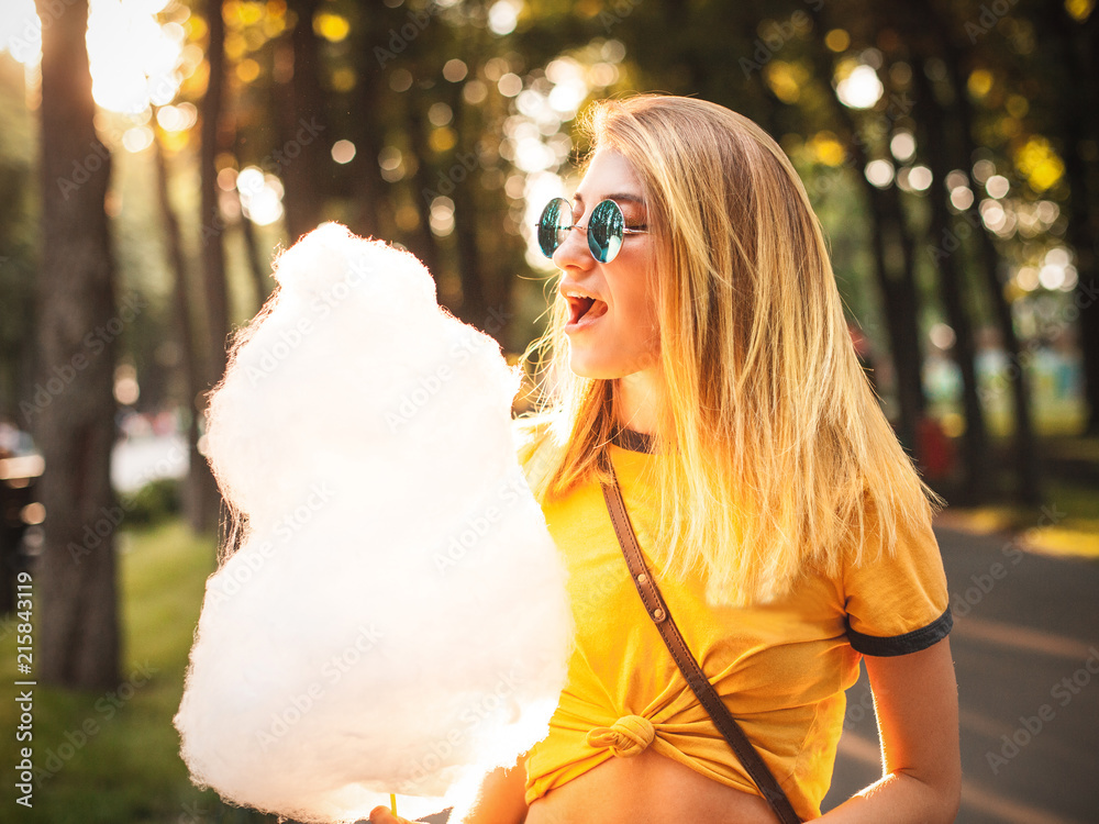 Young woman posing with cotton candy in the park Young woman posing with cotton candy in the park