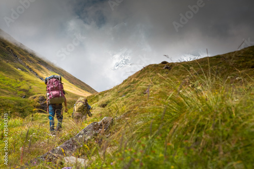 Backpacks and hikers nearing Annapurna Base camp in the Annapurna Himalaya, Nepal.