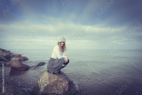 Woman on stones near sea