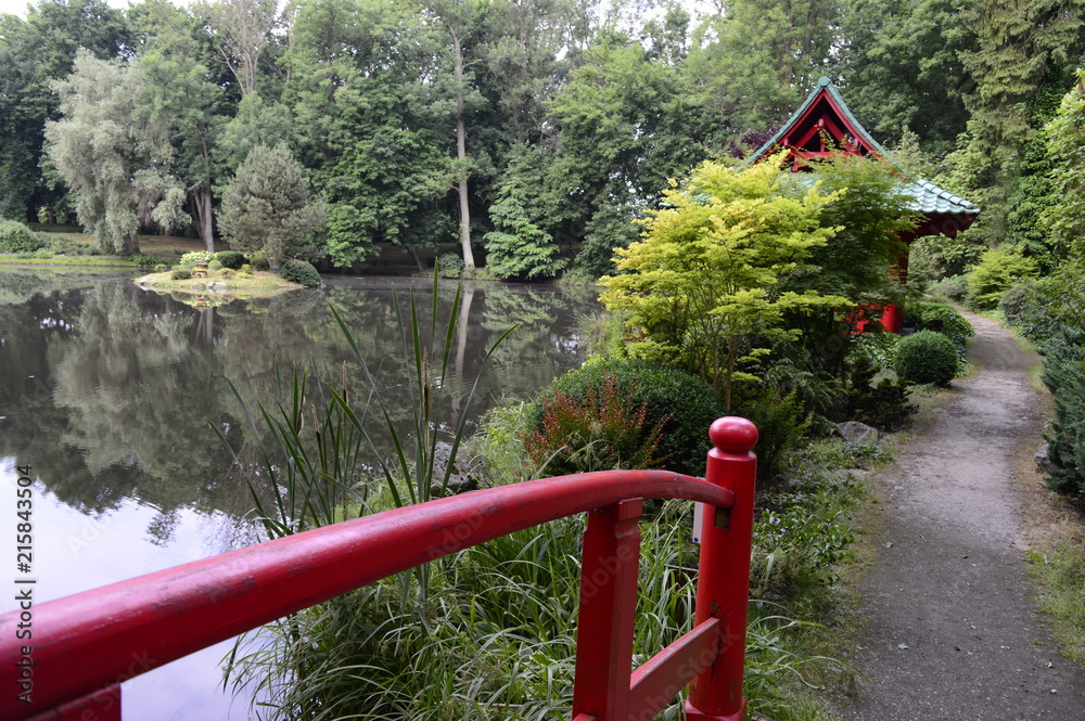 Beautiful Japanese-style garden with red pagoda and bridge Beautiful Japanese-style garden with red pagoda and bridge