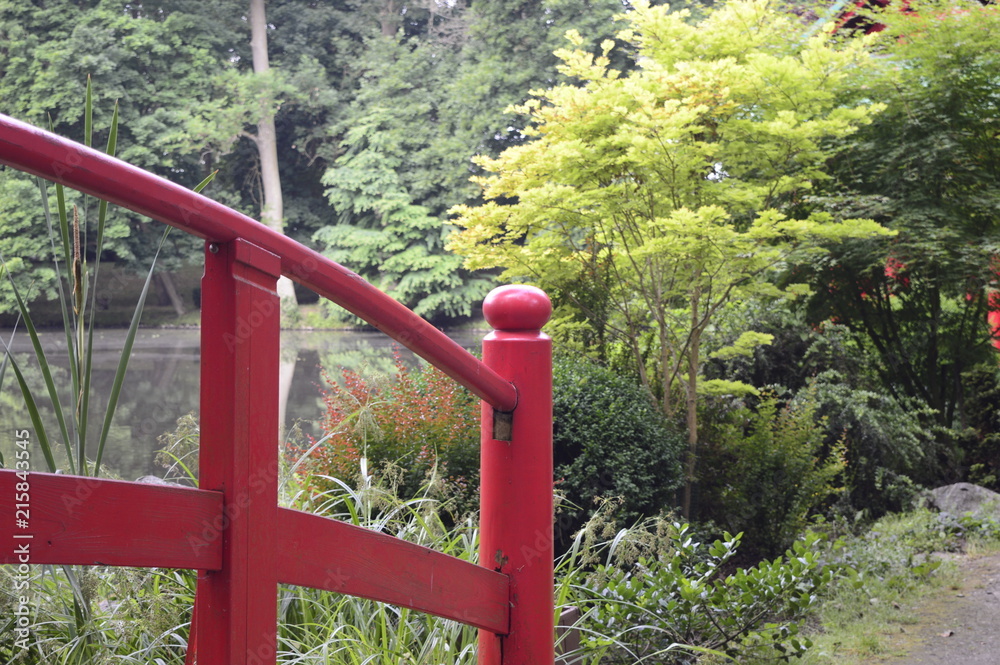 Beautiful Japanese-style garden with red bridge Beautiful Japanese-style garden with red bridge