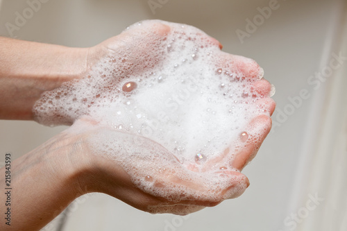 soap foam in female hands photo