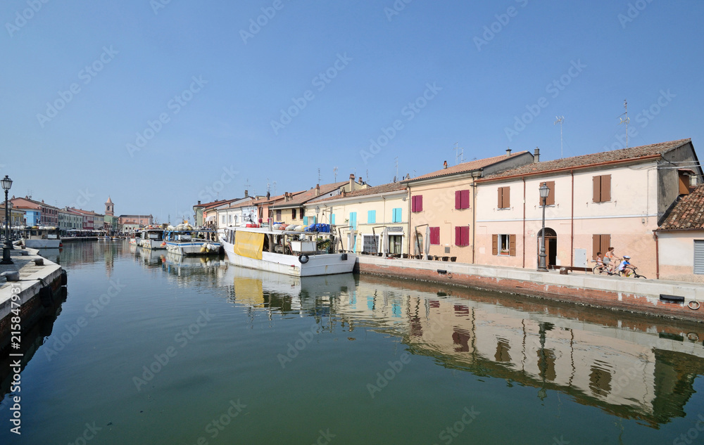 taly, july 2018, Porto Canale of Cesenatico in a sunny day. Some people ride a bicycle