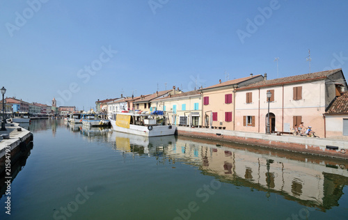 taly, july 2018, Porto Canale of Cesenatico in a sunny day. Some people ride a bicycle