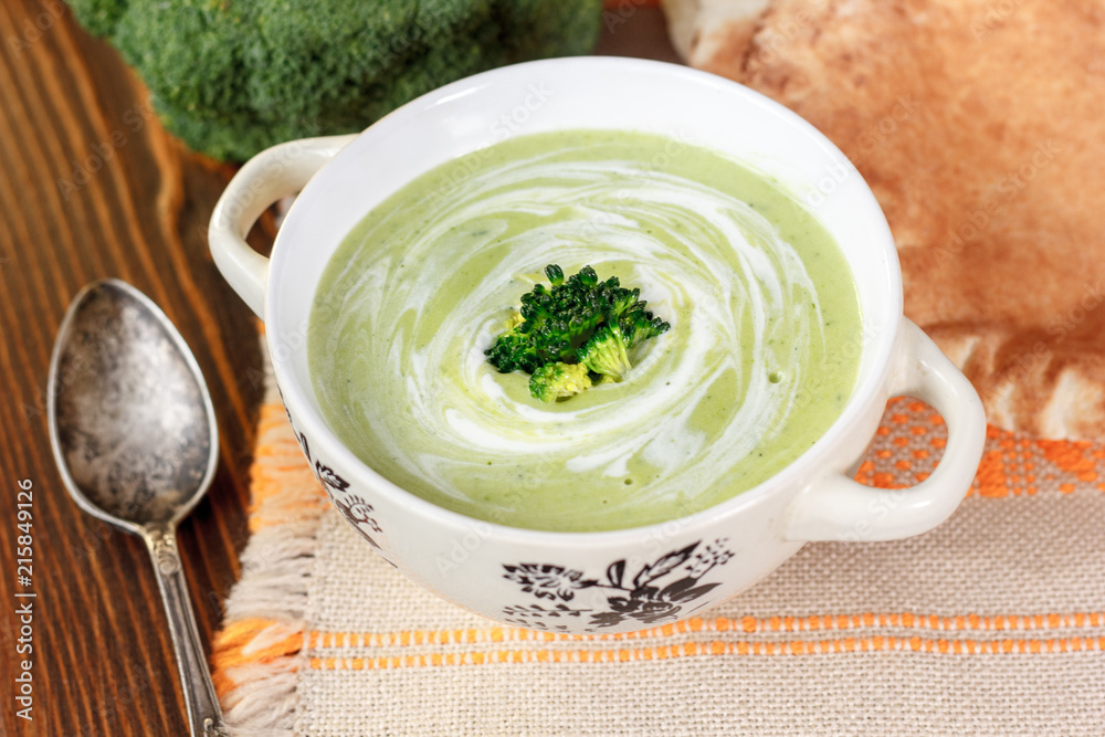 Beautiful vegetarian broccoli soup in a white bowl. Beautiful vegetarian broccoli soup in a white bowl.