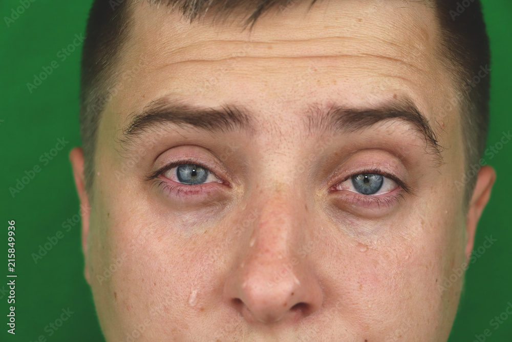 Tears in eyes of crying adult man. Green background. Chromakey Tears in eyes of crying adult man. Green background. Chromakey
