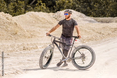 Training a bicyclist in a chalky quarry. A brutal man on a fat bike. 