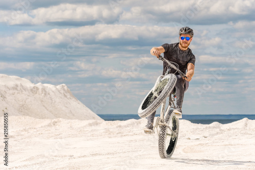 Training a bicyclist in a chalky quarry. A brutal man on a fat bike. 