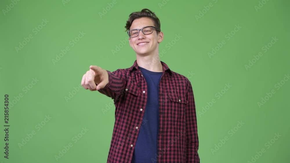 Young handsome teenage nerd boy pointing finger Young handsome teenage nerd boy pointing finger
