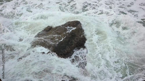 Slow motion shot from above of El Nino driven heavy surf crashing over rocks near Ocean Beach in San Francisco.