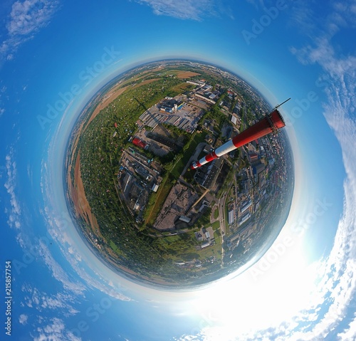 Φωτογραφία High brick chimney in city with green area, aerial little planet view