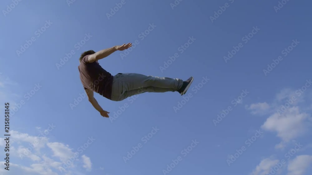 low shot of Freerunner is jumping through the air low shot of Freerunner is jumping through the air