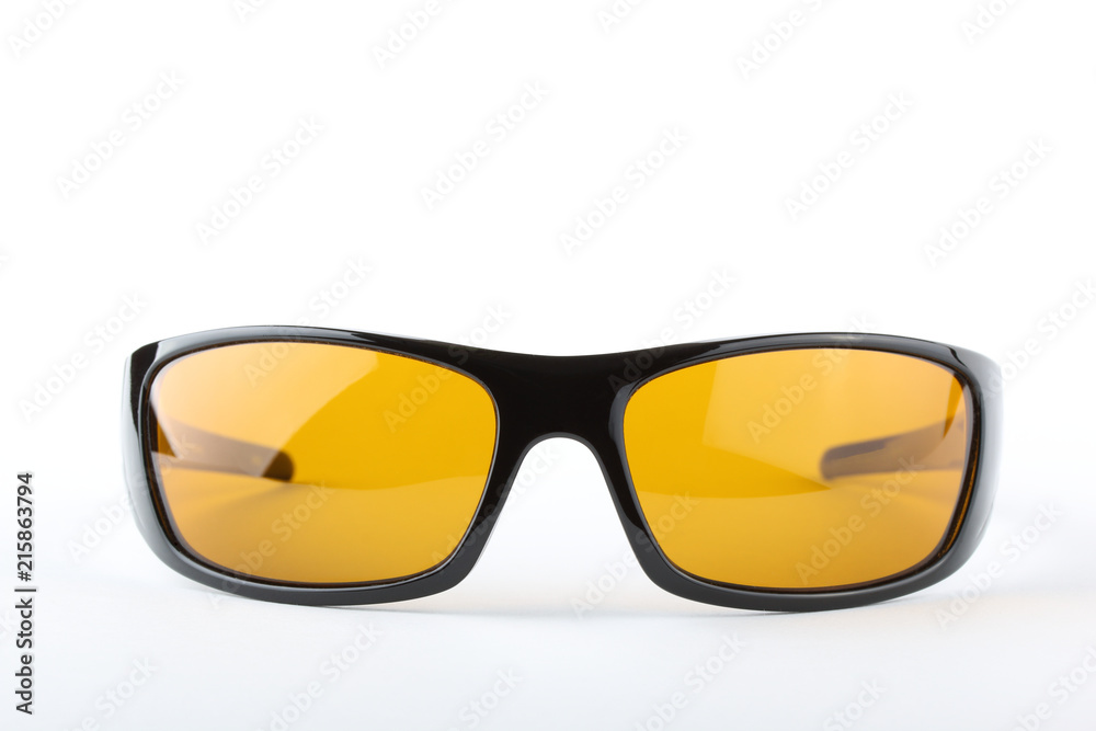 Fototapeta premium Sunglasses with black plastic frame and yellow glass on a white background