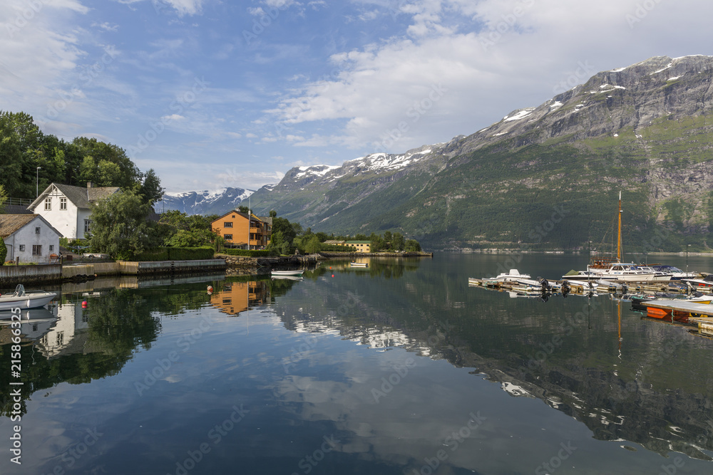 View of Sor fjord from Lofthus with a beautiful reflection of mountains in the background