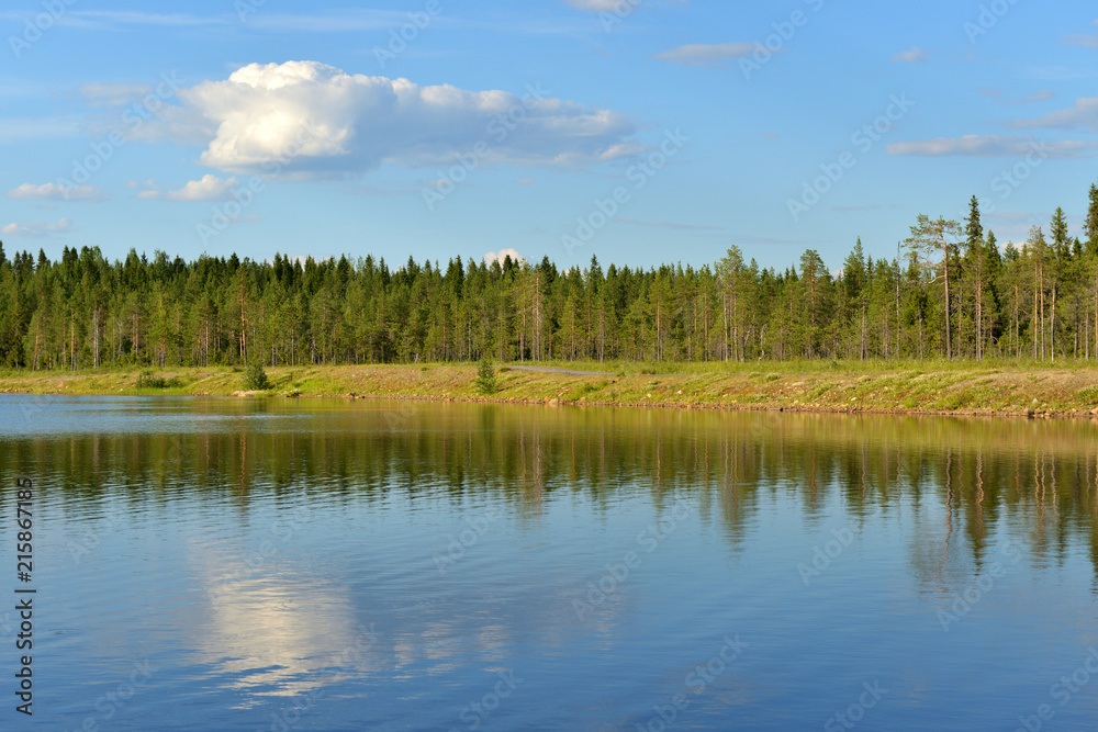 Summer landscape. Forest lake with reflection of cloud in Finnish Lapland Summer landscape. Forest lake with reflection of cloud in Finnish Lapland