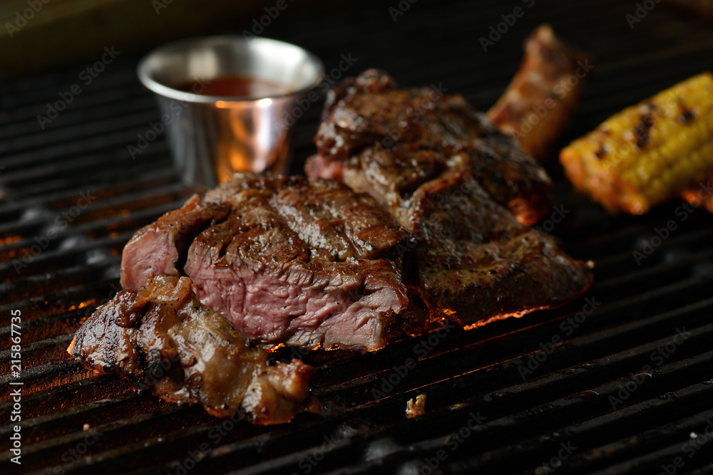 Grilled meat with vegetables and sauce, on the grill Grilled meat with vegetables and sauce, on the grill