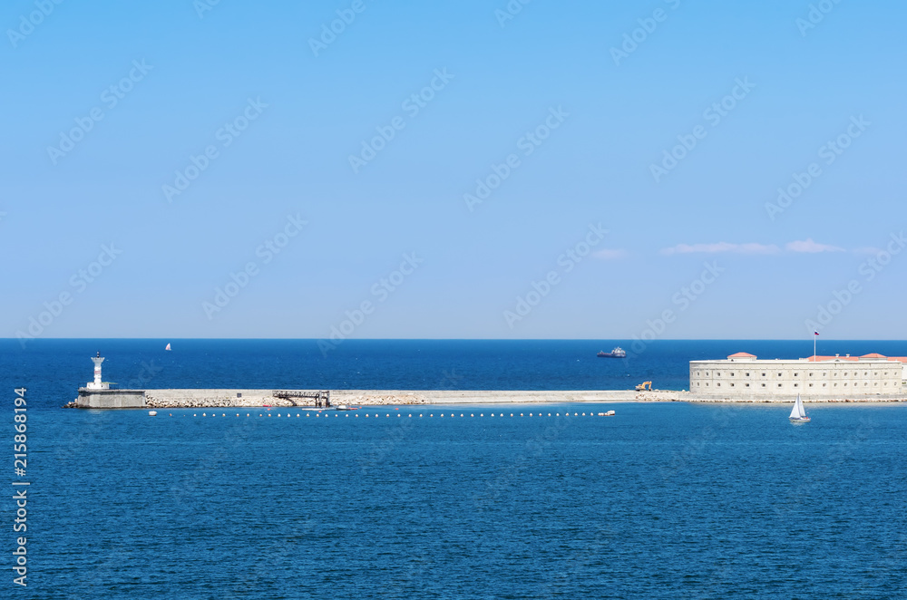 Russia, the peninsula of Crimea, the city of Sevastopol. 06/10/2018: Konstantinovskaya battery and a lighthouse at the entrance to the Sevastopol Bay