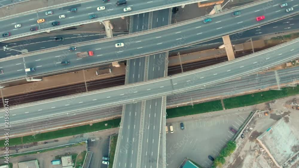 flight of the camera over the traffic junction. Aerial top view of road junction in Moscow from above, automobile and train traffic and jam of many cars, transportation concept. flight of the camera over the traffic junction. Aerial top view of road junction in Moscow from above, automobile and train traffic and jam of many cars, transportation concept.