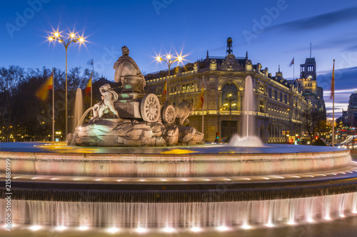 View of Cibeles Fountain in Plaza Cibeles and Calle de Alcala at dusk, Madrid, Spain photo