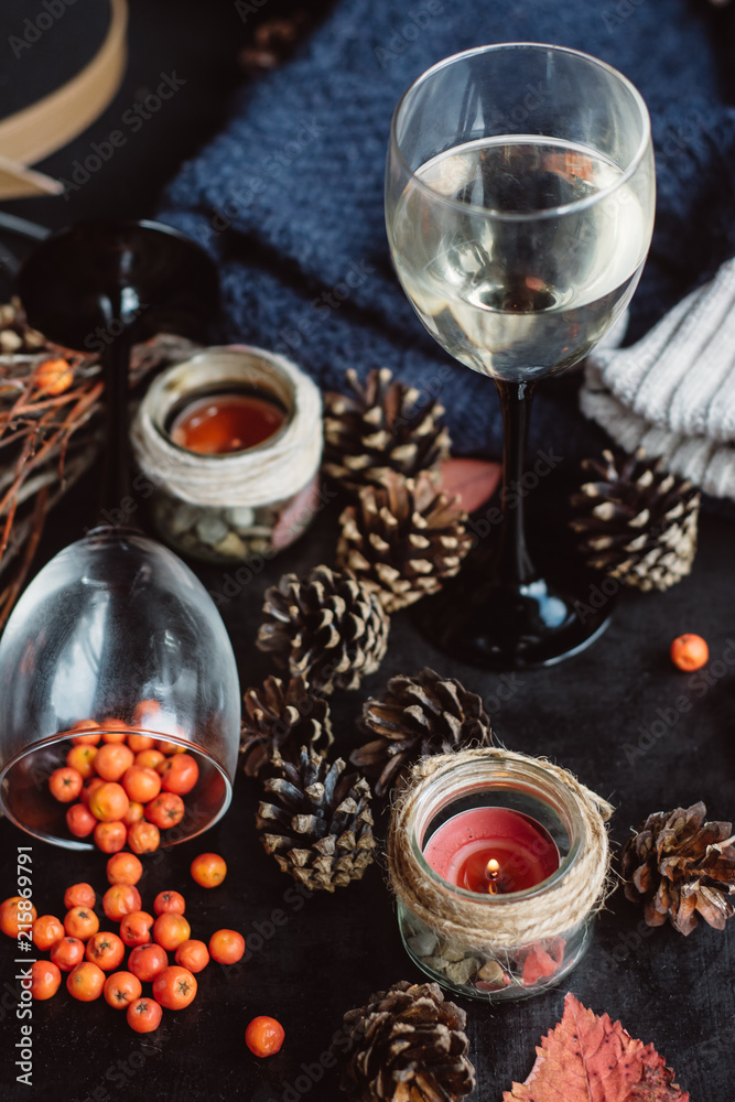 wine in glasses ,red berries,bumps and autumn branches on dark table. Autumn or Winter concept.