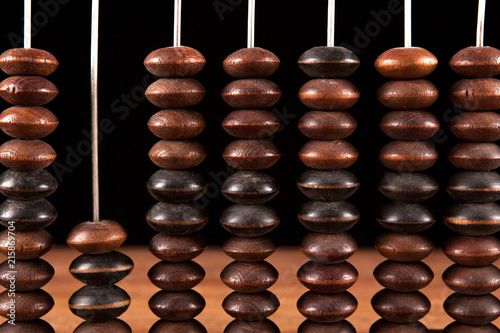 antique abacus with knuckles on a table on a black background