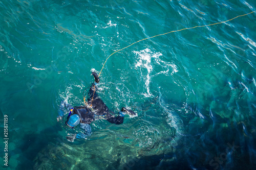 Diver on the surface of bluish © mybixo