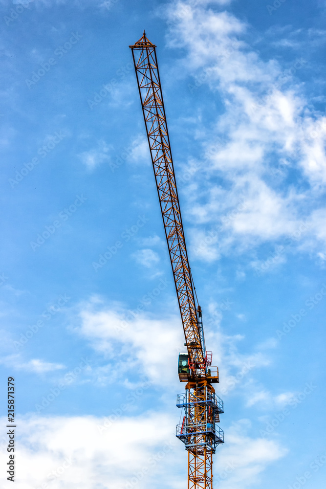 Towers of the cranes. Construction site with cranes against the blue sky. Towers of the cranes. Construction site with cranes against the blue sky.