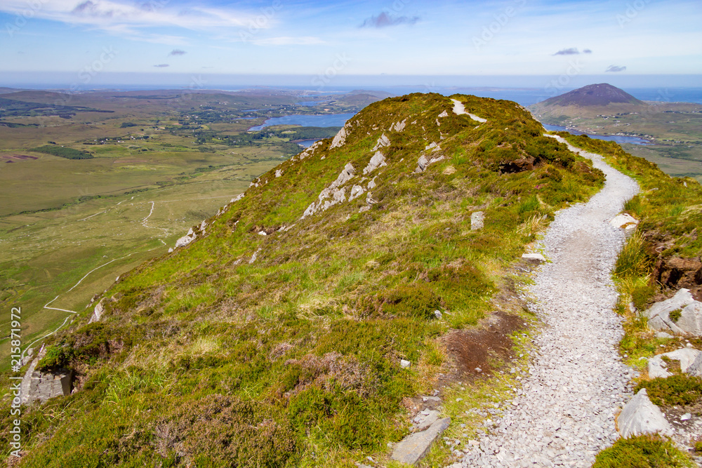 Trail in Diamond hill with Ballynakill Bay and mountains in background Trail in Diamond hill with Ballynakill Bay and mountains in background